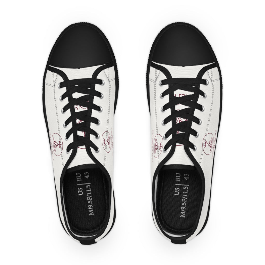 Sovereign Soul .Store white canvas low-top sneakers with black trim, black laces, and a small red emblem detail.