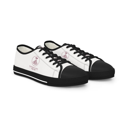 Sovereign Soul .Store white canvas low-top sneakers with black trim, rubber toe caps, and a small logo emblem.