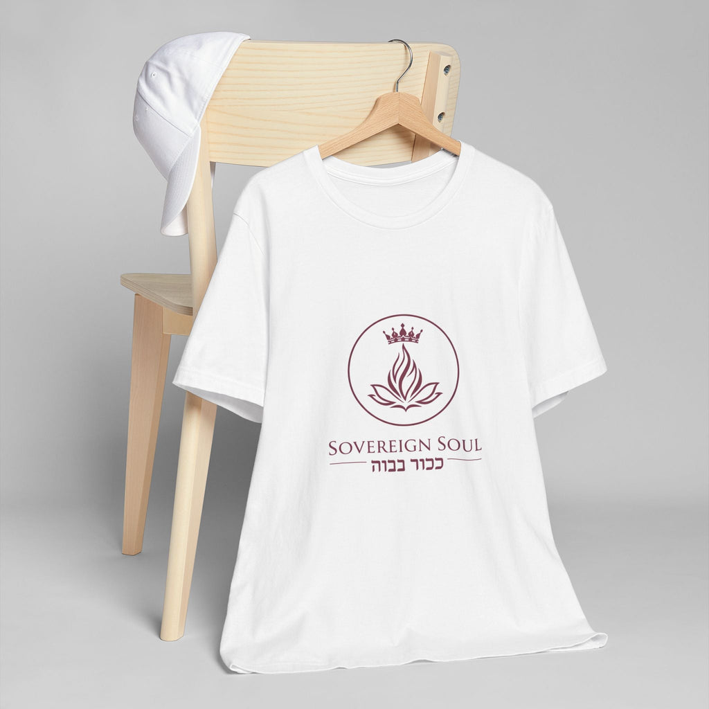 Sovereign Soul .Store white cotton t-shirt featuring a crown and flame logo with Hebrew text on a wooden chair.